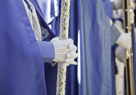 Hands of penitents, detail penitent person dressed in a religious tradition in Spain, Christianity