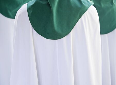 Sheets of Easter, detail of penitents in a procession during Holy Week in Spain, belief and religion