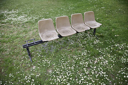 Chairs abandoned in the forest, detail of a battered plastic chairs in natureの写真素材