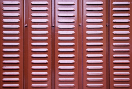 Red metal wall, detail of a red metal wall grille, textured backgroundの写真素材