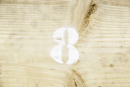 Number eight on wood, detail of a figure painted on a wooden wall, display and informationの写真素材