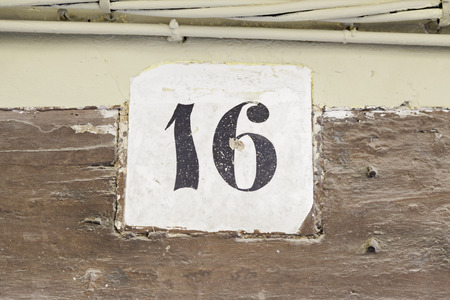 Number sixteen in a wall, detail information about numbers, city explorationの写真素材