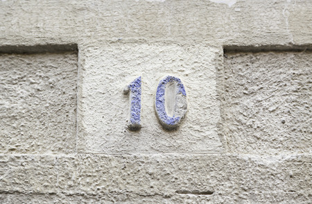 Number ten on a stone wall, detail of a number of information on a wall in the city, ancient and oldの写真素材