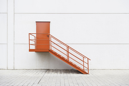Red metal staircase on the outside, detail of a red painted ladder, urban decorationの写真素材