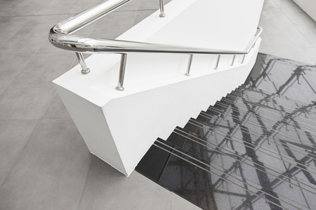 Black marble stairs, detail of stairs with metal railing and white, modern architecture, reflection and cleaningの写真素材