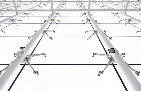 Glass roof with white beams, detail of a roof with sky views, safety and security