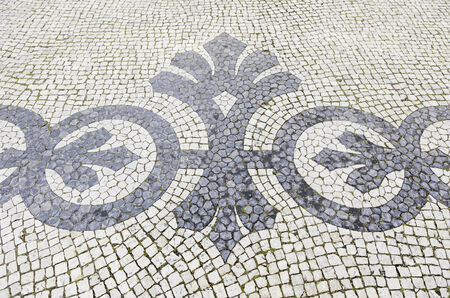 Lisbon typical mosaic, detail of a typical floor of Portugal, decorative mosaic on a typical street of Lisbonの写真素材