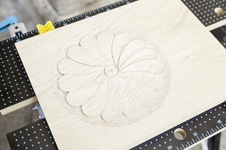 Carved wood with a drawing, detail of a decoration on a wooden boardの写真素材