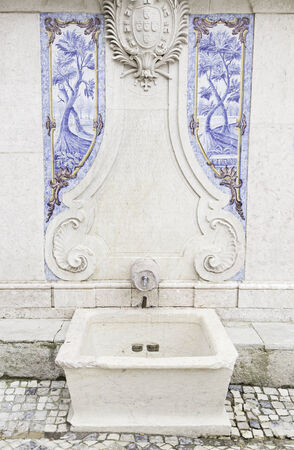 Old stone fountain, detail of a fountain with decorative tiles, ancient monumentの写真素材
