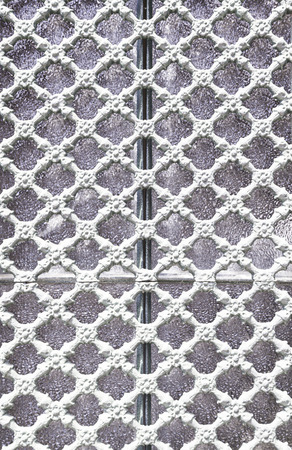 Old metal gate decorated, detail of an old fence painted white, protection and decorationの写真素材