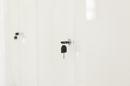 Key in a lock door, detail of a metal key in a lock, protection and securityの写真素材