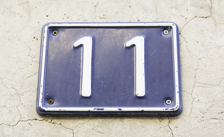 Number eleven a wall of a house, detail of a number of information, odd number