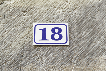 Number eighteen in a wall of a house, detail of a number of information, even numberの写真素材