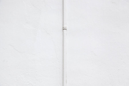 White wall with pipeの写真素材