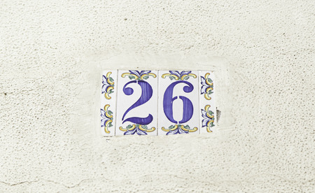 Number twenty-six on the wall of a house, detail of a number of information, even numberの写真素材