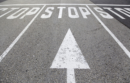 Stop sign on asphalt, detail of a traffic signalの写真素材