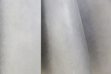 Metallic background with shapes, detail of a textured, matte steel
