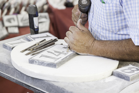 Person carving stone, detail of a manual and craft workの写真素材