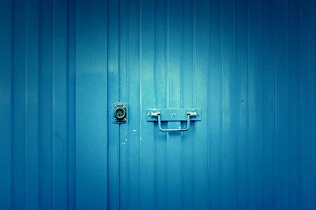 Blue metal door, detail of a closed door painted blueの写真素材