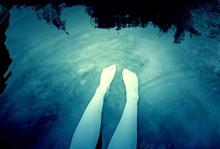 Feet wet in a river, detail relaxing in nature, summer and heatの写真素材