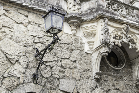 Old street lamp on a wall, detail of city lighting, electricity and lightの写真素材