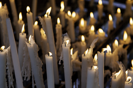 Candles lit at night, detail of an element of light, beliefs and faith, flameの写真素材