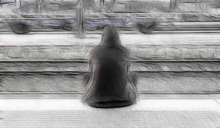 Woman sitting in a train station, detail waiting to grab a trainの写真素材