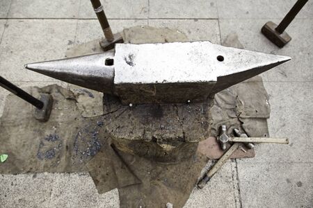 Anvil, hammer, detail of a forge, working with ironの写真素材