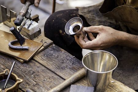Working with iron and a welder, detail of old craft craftsmanの写真素材