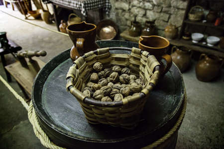 Dry walnuts in a christmas basket, detail of holiday celebration, healthy foodの写真素材