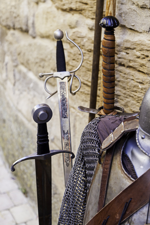 Ancient sword in a knight of medieval warfare, detail of weapon and deathの写真素材