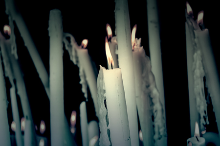 Wax candles lit with fire, detail of belief and faith, decoration and faith, relaxの写真素材