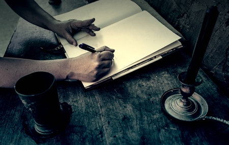 Old medieval desk with pen and book, detail of place to read and writeの写真素材