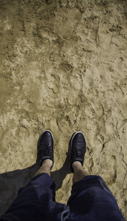 Feet with slippers on the beach, relaxing detail on the seaの写真素材