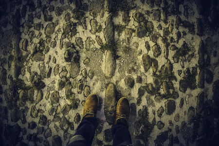 Feet with boots on the street, detail of modern footwear, cold in winterの写真素材