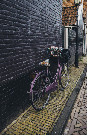 AMSTERDAM,NETHERLANDS - SEPTEMBER 06, 2018: Sunset in Amsterdam.Bicycle parking and traditional old dutch buildings.Flower market on Single canal, Netherlandsのeditorial素材