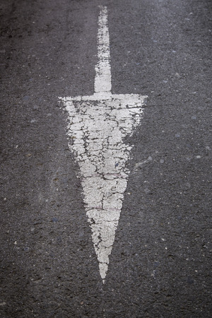 Direction arrow on the asphalt, road sign for vehicles