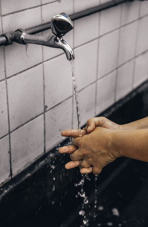 Washing hands with water, cleaning and hygiene detailの写真素材