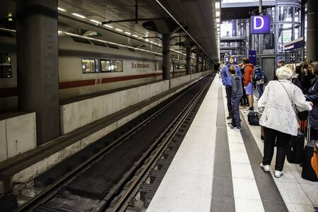 BERLIN, GERMANY - SEPTEMBER 08 2019: A platform of the Berlin East Railway station with a waiting traveler and a tram on September 08, 2019 in Berlin / Platform Berlin Railway Stationのeditorial素材