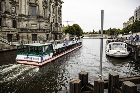 BERLIN, GERMANY - SEPTEMBER 08 2019: Small boat in front of Berlin Cathedral (Berliner Dom) and Museum Island (Museumsinsel) reflected in Spree River, Berlin, Germany, Europe.のeditorial素材