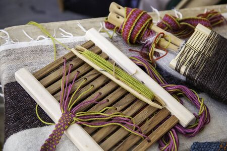 Spinning with a wooden spinning wheel, handicraft detail, thread manufacturing