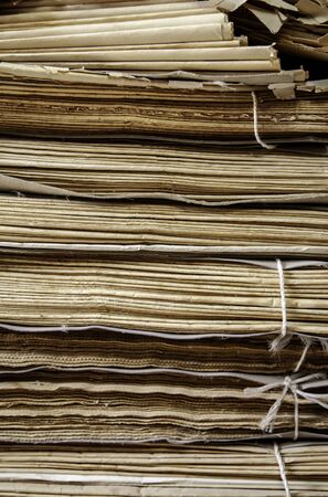 Old damaged newspapers, detail of old and abandoned cellarの写真素材
