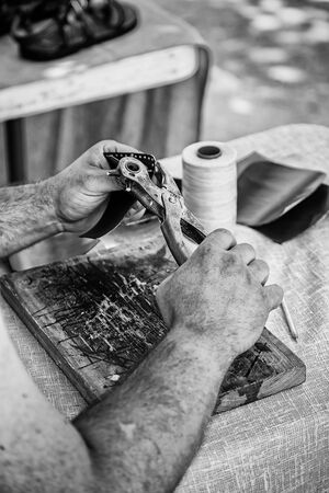 Man working with leather, detail of a person working with your handsの写真素材