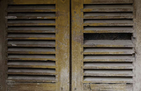 Old and abandoned wooden window, detail of architecture and ruinの写真素材