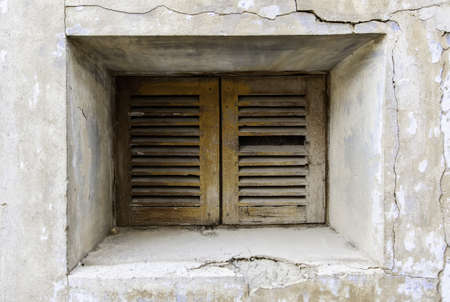 Old and abandoned wooden window, detail of architecture and ruin