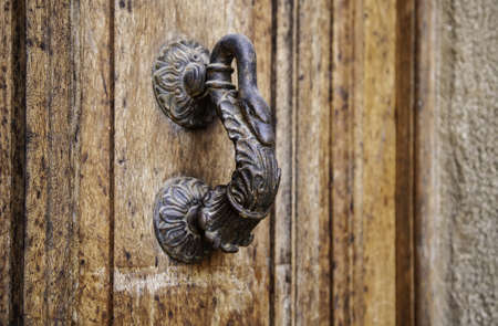 Old rusty door knocker, decoration and communication detail, vintage