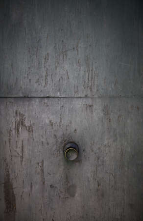 Old metal door with rusty knob, security detail on a doorの写真素材