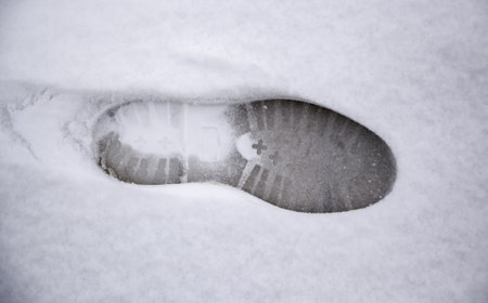 Detail of person's footsteps on a cold and winter day
