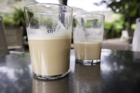 Detail of drink with caffeine and milk, refreshment and relaxation on a terrace