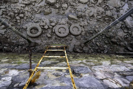 Detail of stairs to access the water in an old loading dock